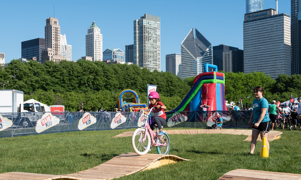 child riding bike in obstacle course
